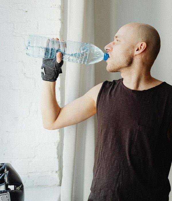 Man performing a controlled strength exercise in a minimalist gym.